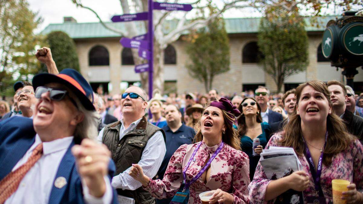 A woman cheers for his pick in the Big Ass Fans Dirt Mile during the 2022 Breeders’ Cup World Championships at Keeneland in Lexington, Ky., Saturday, November 5, 2022.