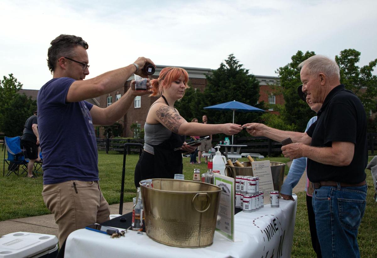 Wine and Market co-owner Seth Brewer and store manager Brooke Jennett sell drinks during the weekly Big Band and Jazz performance at the MoonDance Amphitheater in Lexington, Ky., on June 1, 2021. Wine and Market will be selling beverages and pre-ordered charcuterie boards at every Big Band and Jazz performance for this season.