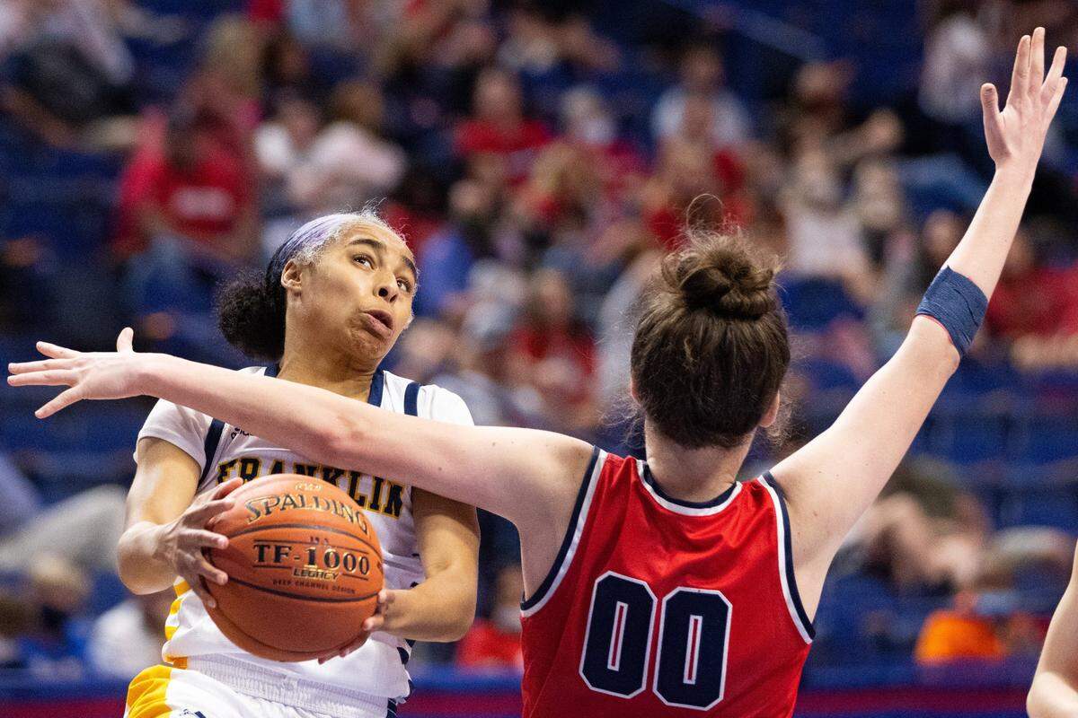 Franklin County senior Brooklynn Miles is fouled by Anderson County’s Jacie Chesser (00). Miles, the 11th Region player of the year in 2021, was held to four points.