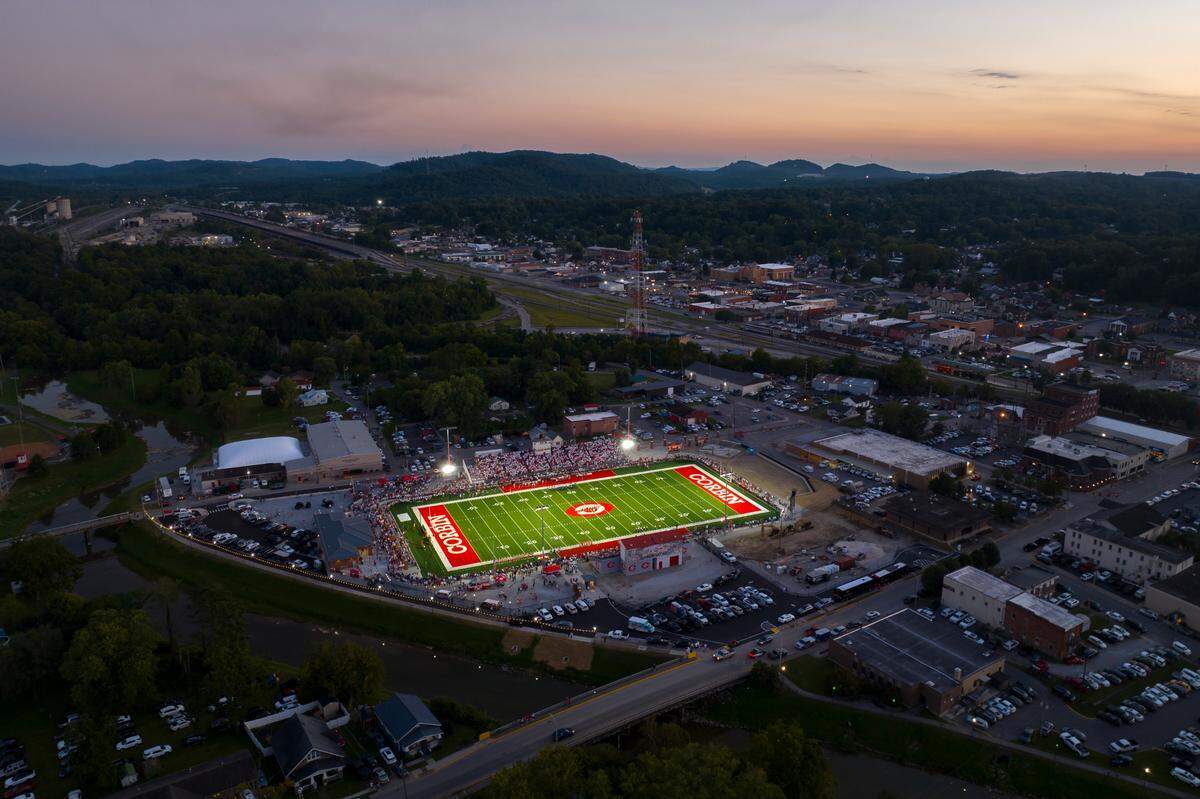 The national anthem is played before the start of a game between Corbin and Frederick Douglass at Corbin High School’s at the newly remodeled Campbell Field in Corbin, Ky., on Friday, Sept. 15, 2023. The Corbin Redhounds thrilled most of the estimated 7,000 fans with a dramatic goal-line stand to clinch their 6-0 victory over Frederick Douglass. Following the game, Corbin’s four-star defensive standouts Jacob and Jerod Smith thrilled thousands more University of Kentucky football fans by announcing their commitment flip from Michigan to UK.