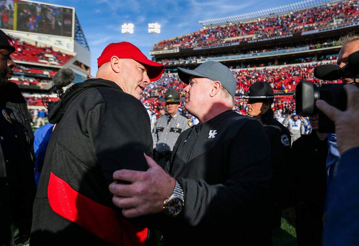 Louisville coach Jeff Brohm congratulated Kentucky head man Mark Stoops after the Wildcats upset the No. 9 Cardinals 38-31 last season to retain the Governor’s Cup trophy for the fifth consecutive meeting between the Cats and Cards.