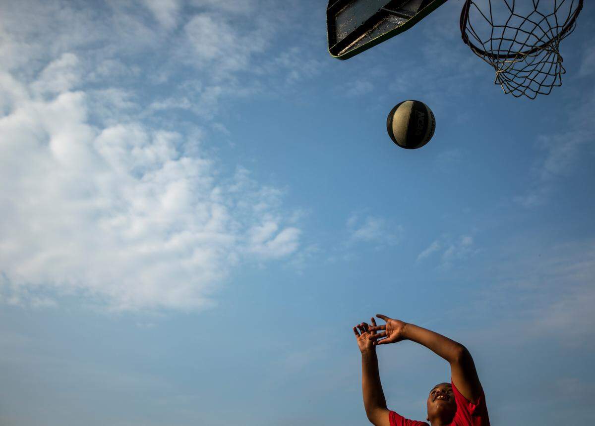 Tarelle Graham, 14, of Lexington, shoots the ball while playing basketball with his brothers at Charles Young Park in Lexington, Ky., Thursday, July 11, 2019.