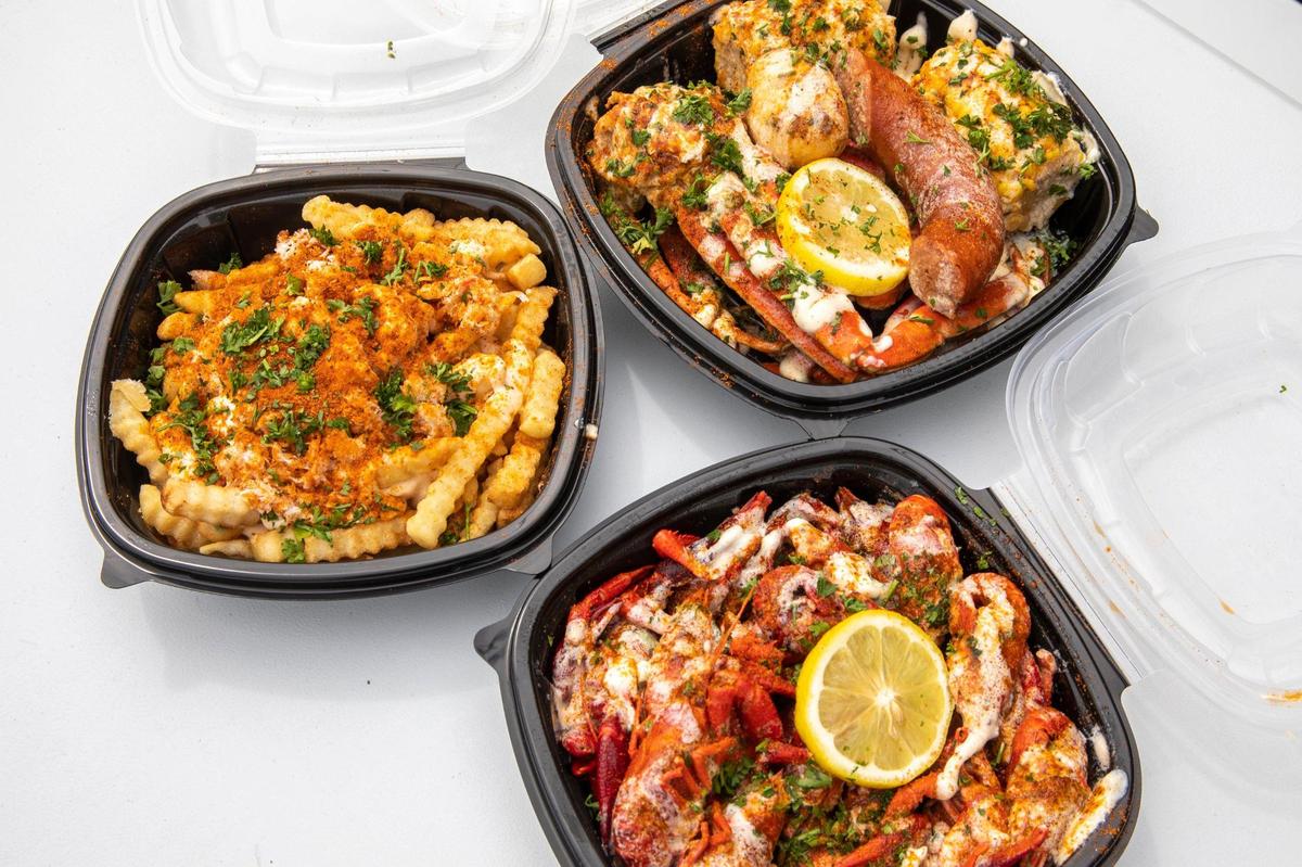 Chee-sea fries, clockwise from left, a serving of the snowcrab boil, and crawfish at Seafood Lady at 833 Georgetown Street in Lexington, Ky., on Thursday, Aug. 28, 2020. Seventy-five percent of their seafood comes directly from the Gulf Coast.