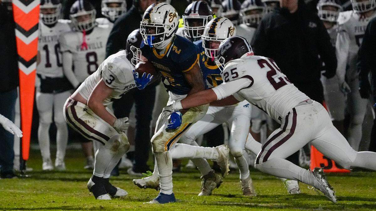 Sayre’s Brock Coffman (2) is brought down by Pikeville’s Isaiah Hurt (25) during Friday’s game.