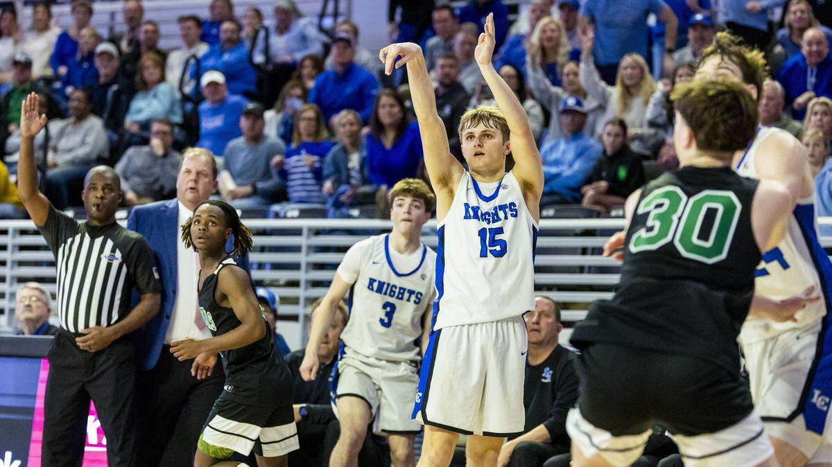 Lexington Catholic's Jacob Holland (15) makes a last-minute three-pointer during the Knights' 42-41 win over the Defenders in the quarterfinals of the boys basketball 11th Region Tournament, Wednesday, March 4, 2026 at Eastern Kentucky University's Baptist Health Arena in Richmond, Ky.