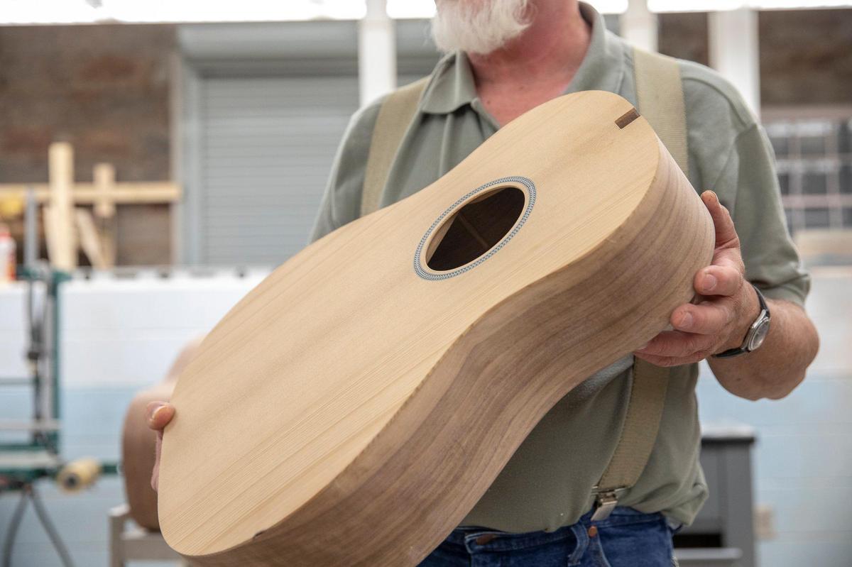 Doug Naselroad, Troublesome Creek Stringed Instrument Company director, discusses a guitar that is under construction in Hindman, Ky., Wednesday, Oct. 9, 2019.