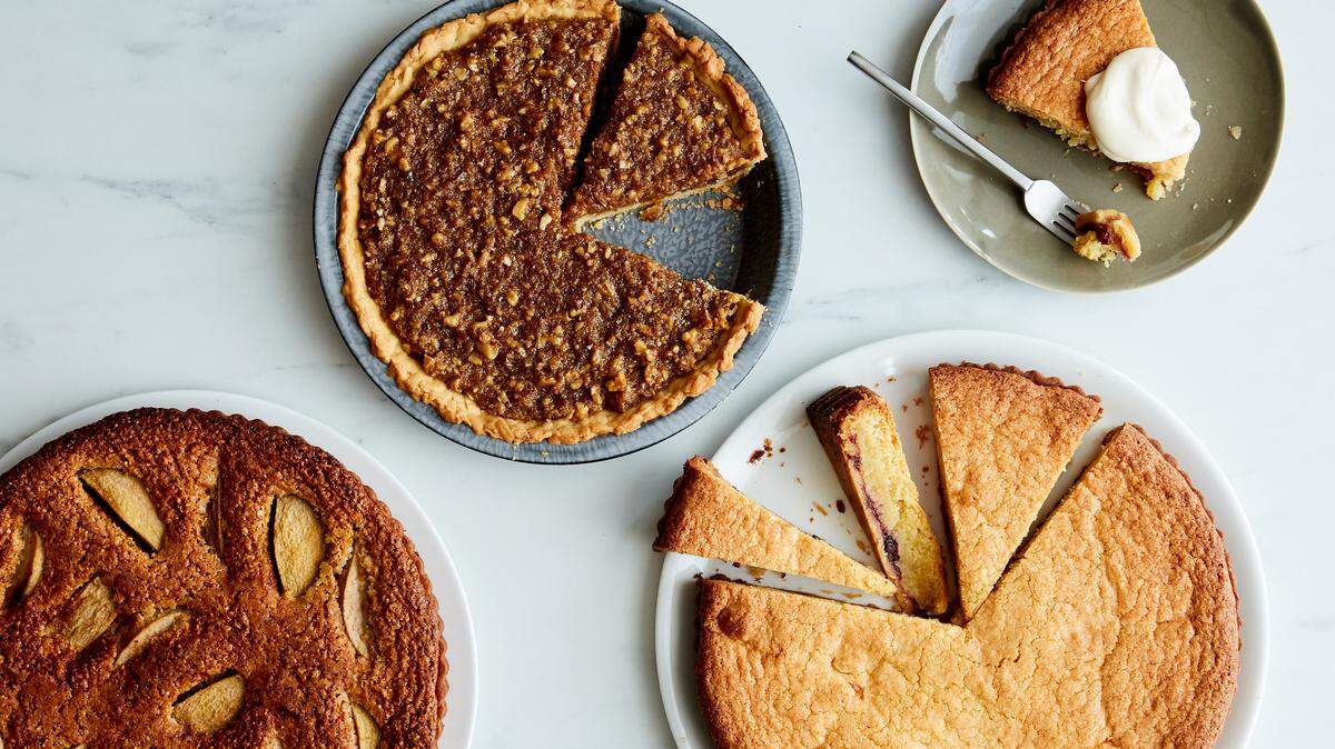 From left, three pies made with buttery, crisp shortcut pie crust: hazelnut, pear and cardamom tart; walnut and molasses pie; and a British bakewell tart with cranberry sauce. Once the chef Clare de Boer learned the grating trick for making pie crusts, she never went back to rolling.