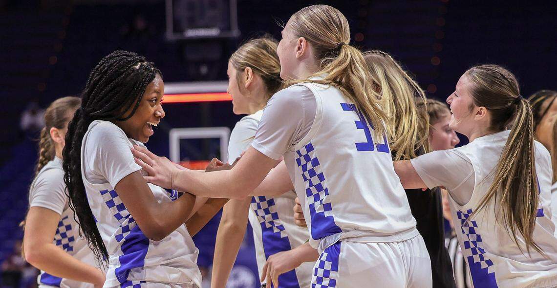 Simon Kenton's Angela Kabeya is greeted by her teammates in a timeout during the third quarter of the Clark’s Pump-N-Shop Girls’ Basketball Sweet 16 first round at Rupp Arena on Thursday.