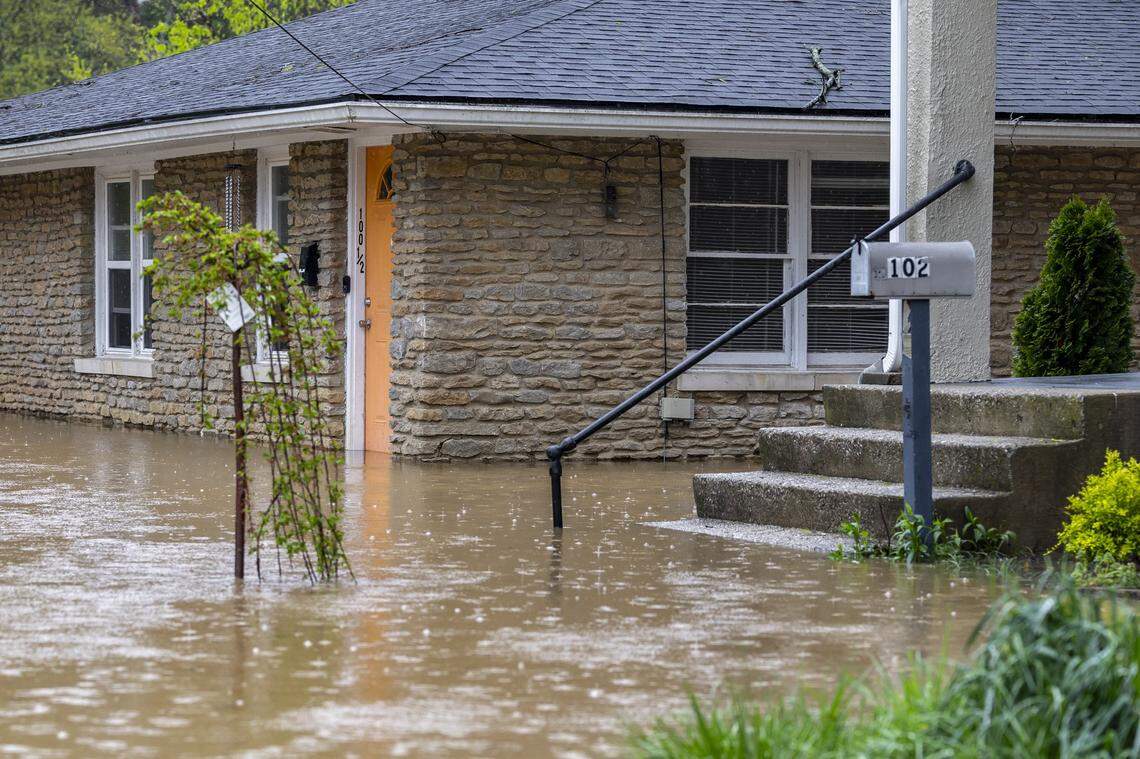 The Kentucky River surrounds a home on Watson Court in downtown Frankfort, Ky., on Saturday, April 5, 2025.
