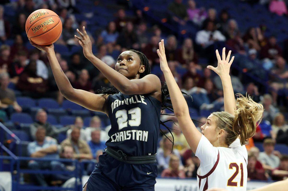 Danville’s Grace Mbugua (23) shoots against Cooper’s Bella Deere (21). Mbugua, a junior forward, finished with 34 points, 14 rebounds and four blocked shots despite battling foul trouble throughout the night.
