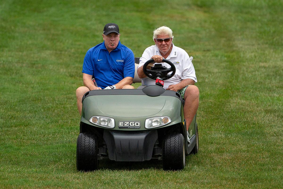 UK football coach Mark Stoops, left, shared a cart with PGA Tour pro John Daly during Wednesday’s Pro-Am event in Nicholasville. Daly will be allowed to use a cart during the PGA Barbasol Championship, which begins Thursday.