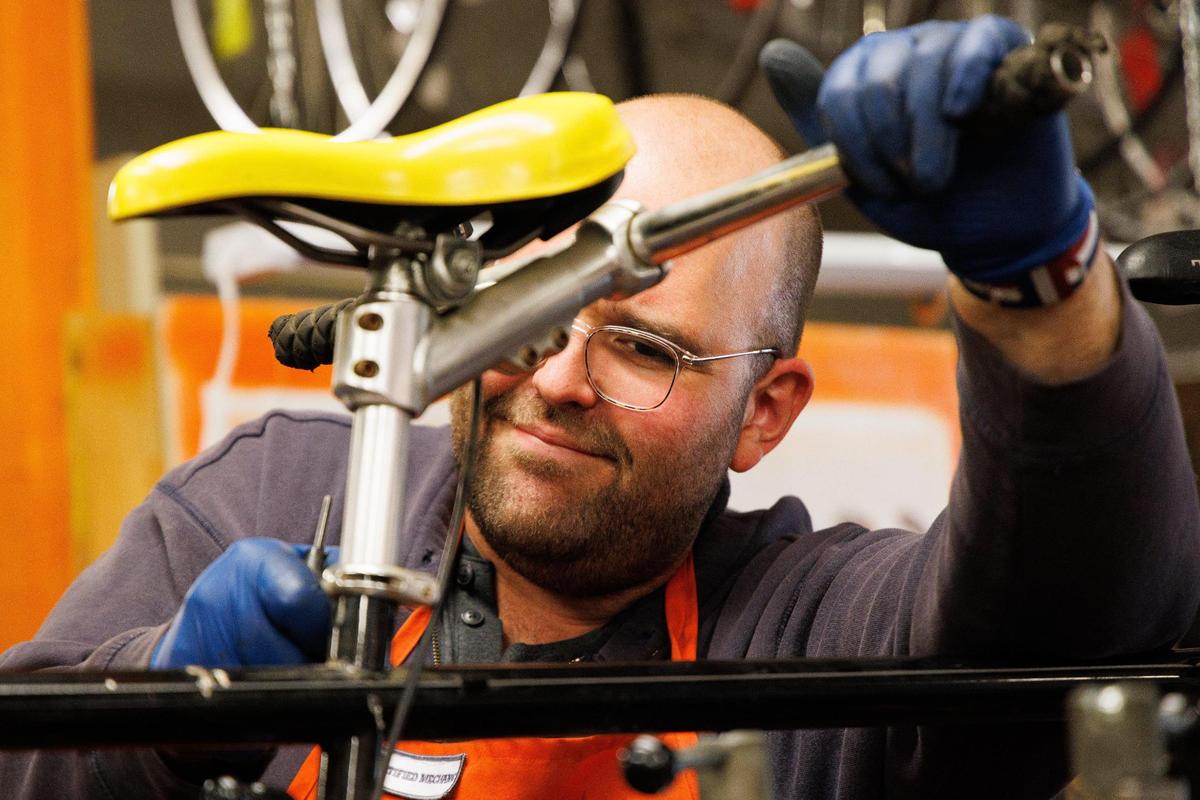 Volunteer mechanic Guy Hamilton-Smith works on a customer’s tandem bicycle on Sunday, May 22, 2022, at Broke Spoke Community Bike Shop in Lexington, Kentucky.