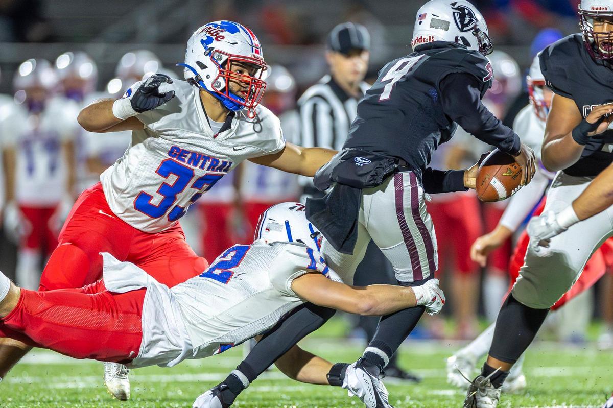 Madison Central’s Cody Morrison (2) wraps up Tates Creek’s Darnell Burnside Jr (9) during Friday’s game.