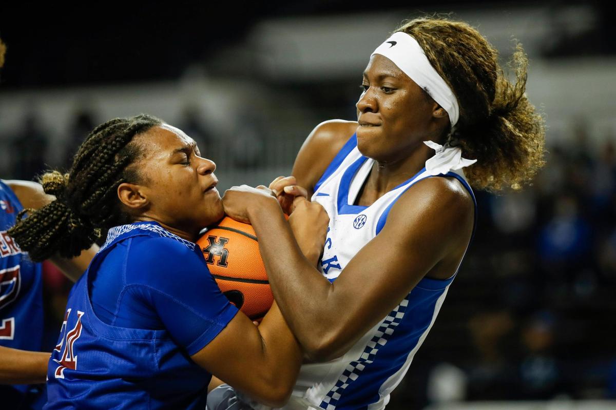 Kentucky’s Rhyne Howard, right, wrestles for the ball with Presbyterian’s Nyah Willis. Howard finished with four steals in addition to 15 points, seven assists, four rebounds and a blocked shot.