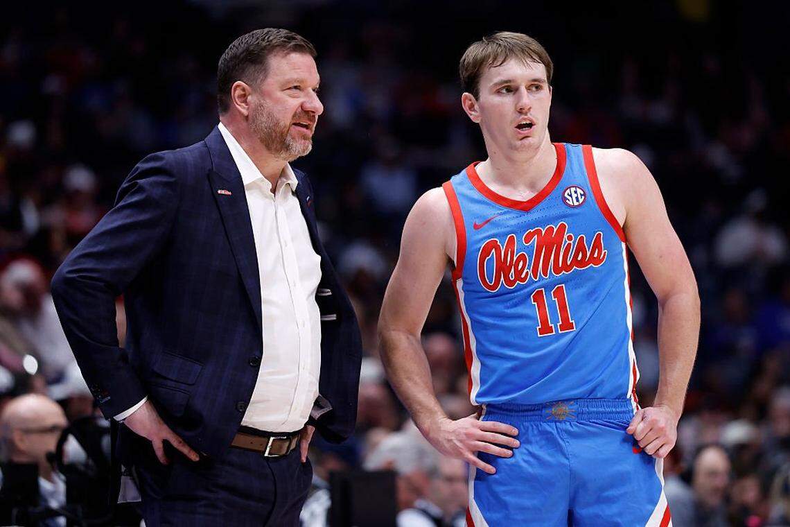 NASHVILLE, TENNESSEE - MARCH 12: Head coach Chris Beard and Travis Perry #11 of the Ole Miss Rebels look on during the first half against the Georgia Bulldogs in the second round of the 2026 SEC Men's Basketball Tournament at Bridgestone Arena on March 12, 2026 in Nashville, Tennessee.  (Photo by Johnnie Izquierdo/Getty Images)