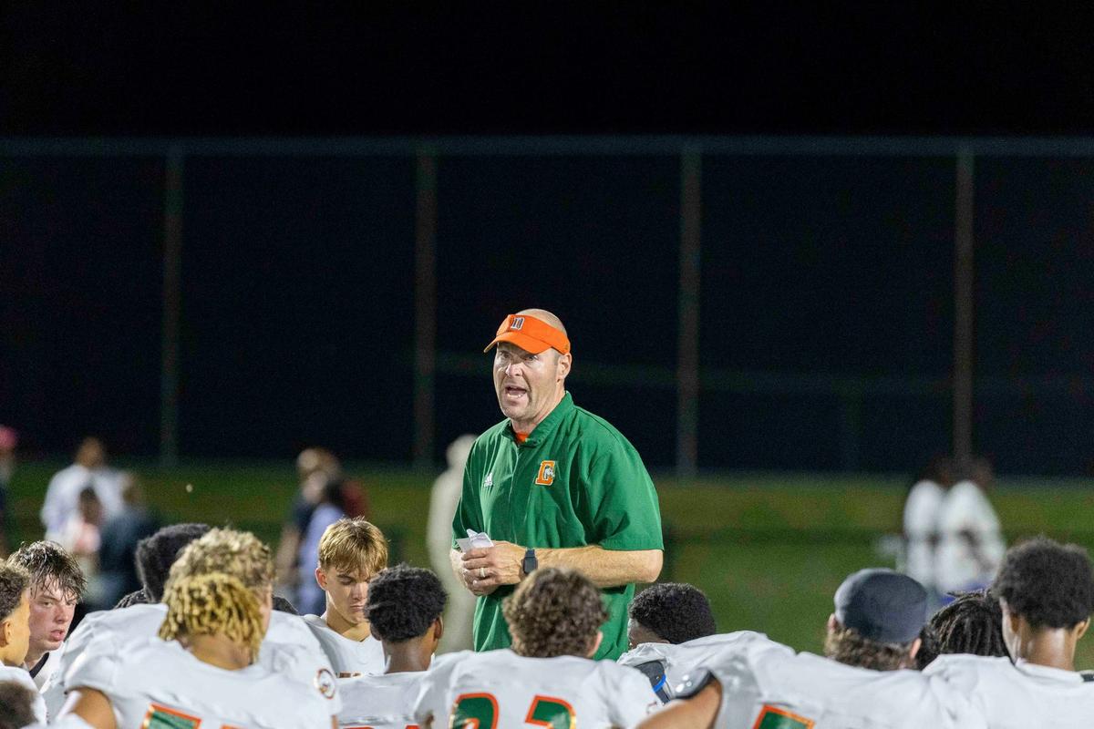 Frederick Douglass head coach Nathan McPeek speaks to his team after their victory over the host Commodores at Tates Creek High School on Sept. 13. Douglass hosts No. 1 Male this week.