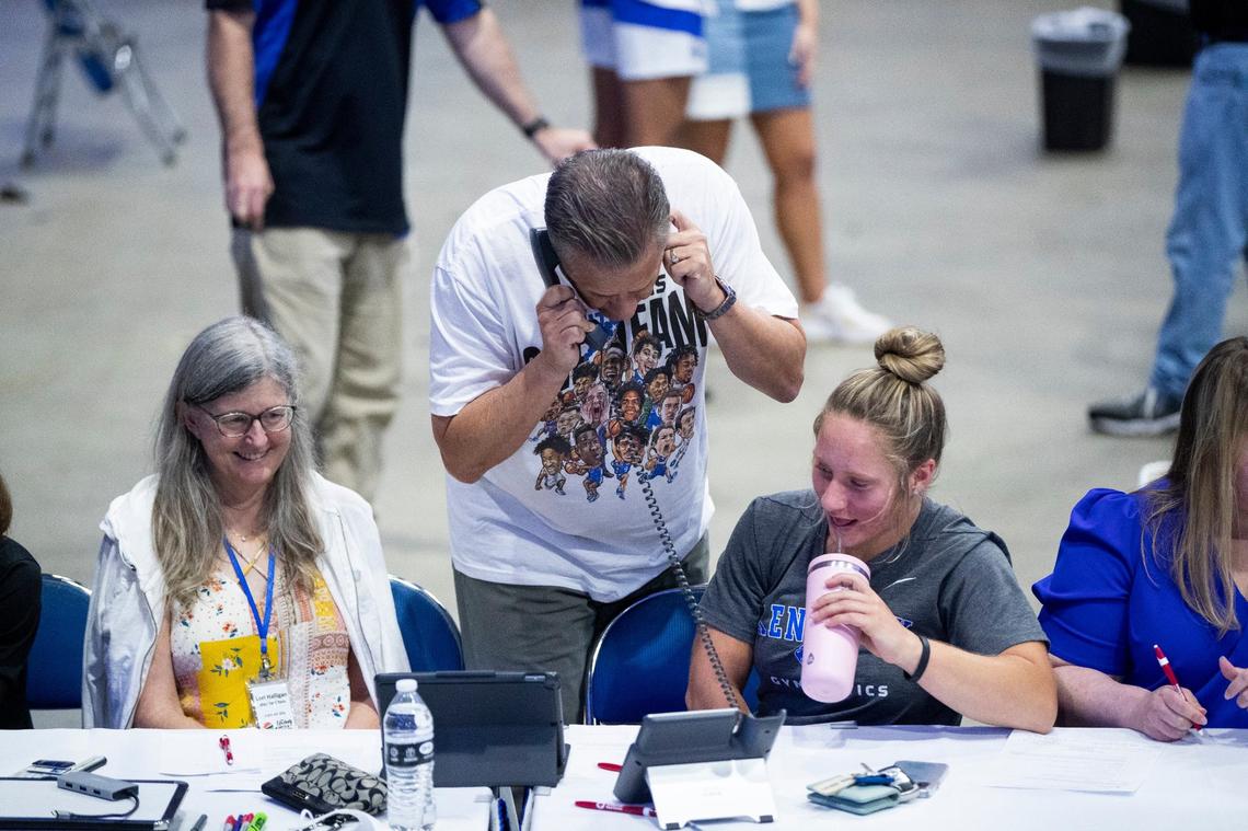 John Calipari works the phones during an open practice and telethon to raise money for flood relief.