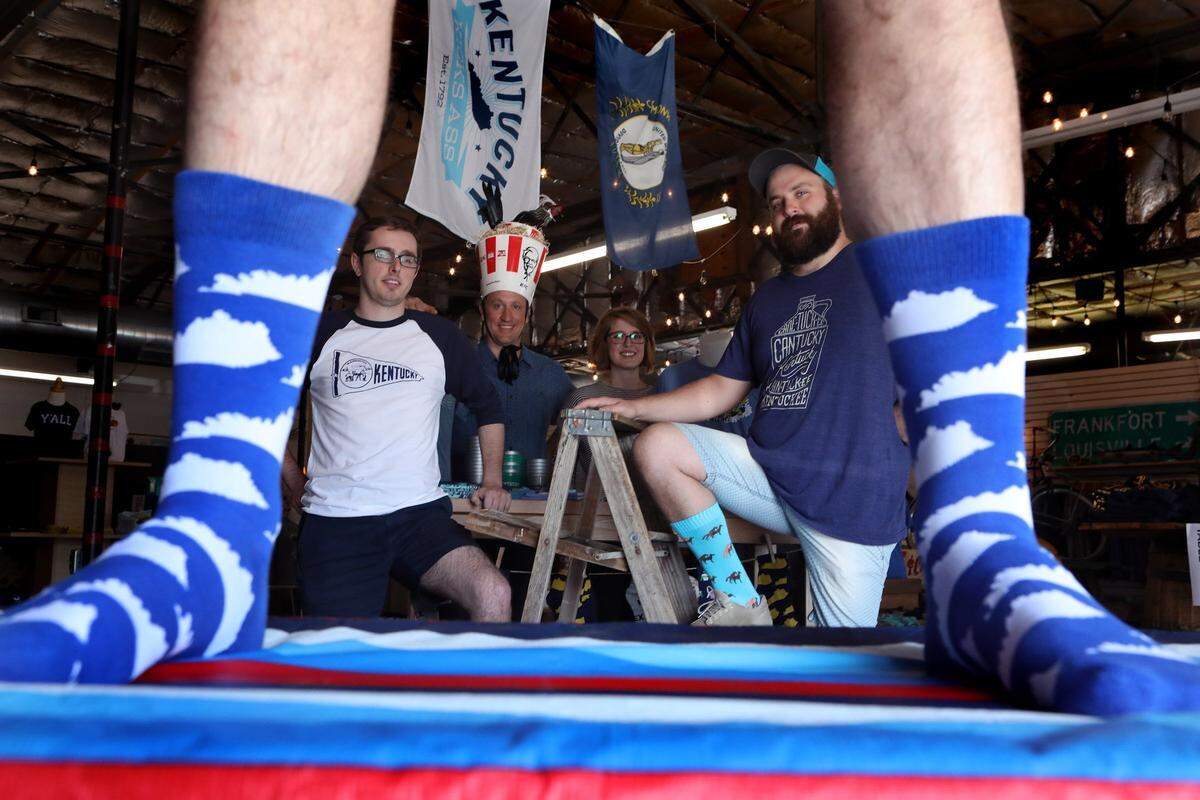 Alex Saunders, Whit Hiler, Lucy Chandler and Erick Moore are framed by the original design offered by Southern Socks.
