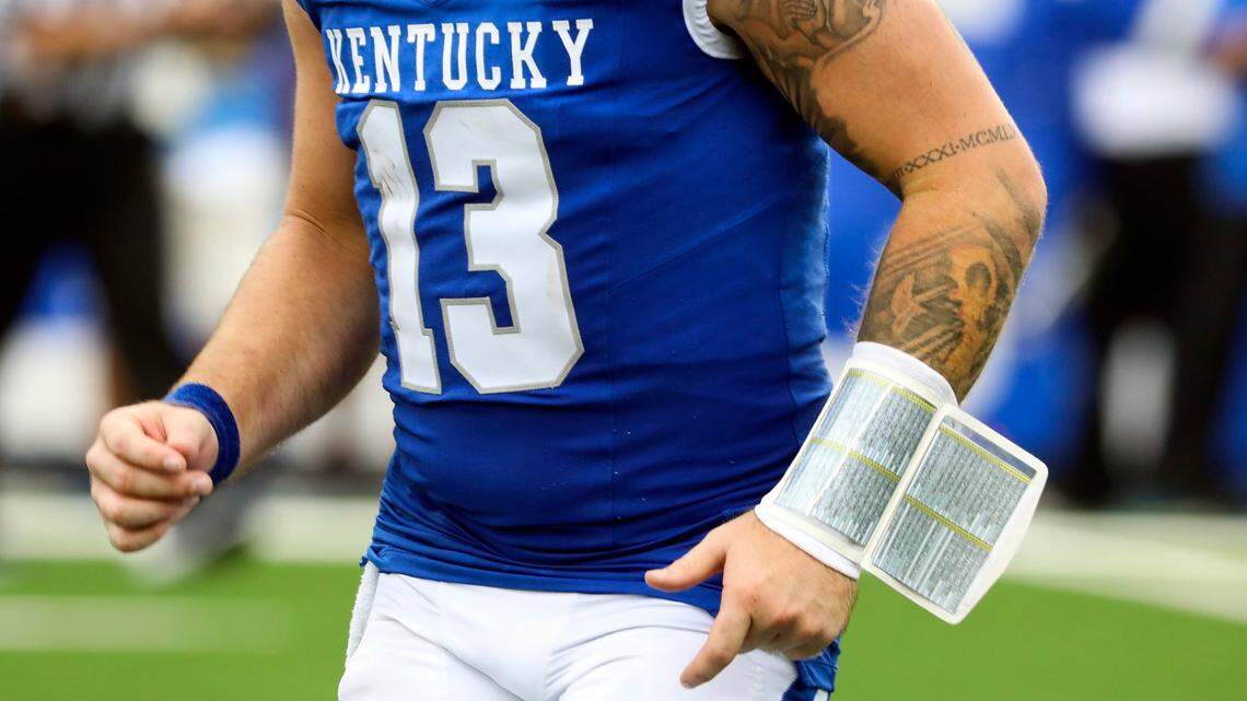 Kentucky quarterback Devin Leary calls plays in the huddle with the aide of a wristband. That process has not always gone smoothly this season.