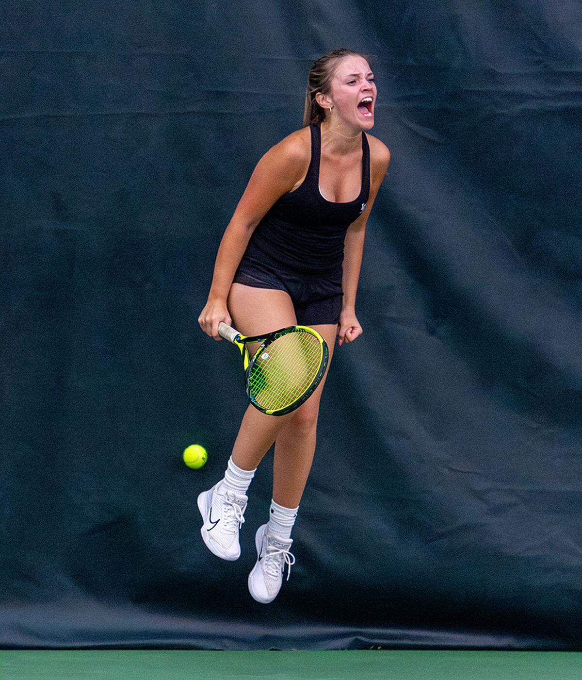 Lexington Catholic’s Sophia Miller celebrates Friday after her doubles win with Eva Quinn in the 11th Region championships at the Bluegrass Racquet Club in Nicholasville.