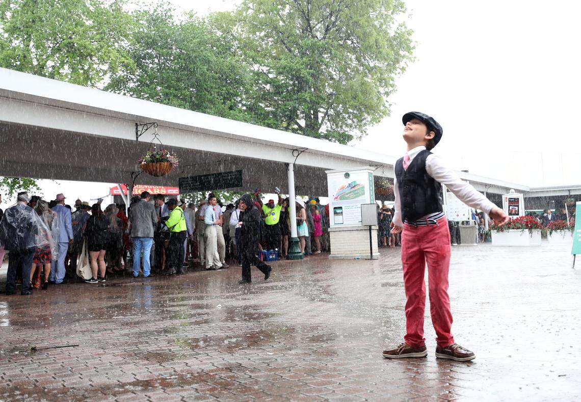 LAndon Culver, 10, plays in the rain before the races. "It's awesome!" he said of his first Derby. 
