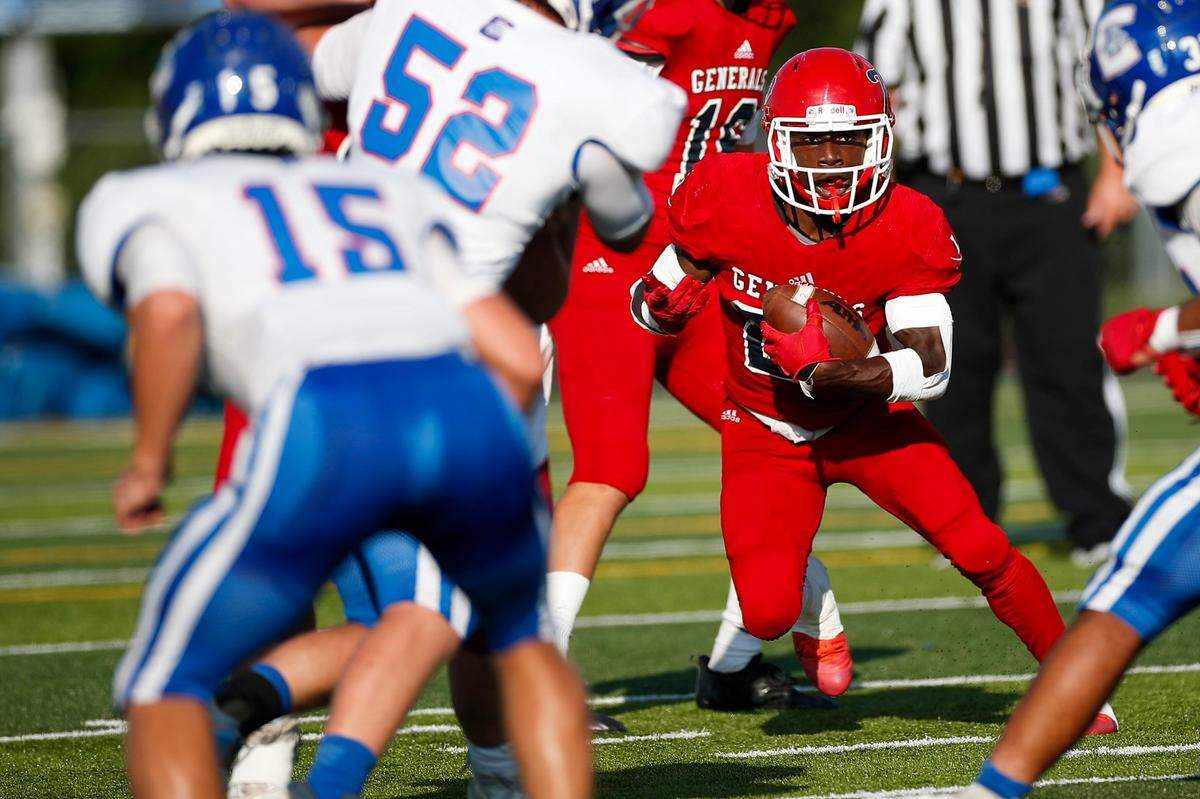 Lafayette’s Jeawon Kendrick, right, ran the ball around Conner’s Cooper Elliston (52) during Friday’s game.