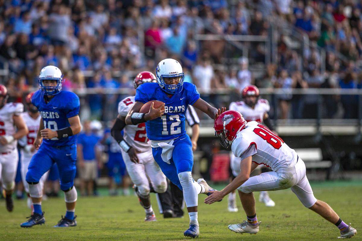Breathitt County quarterback Braxton Ohara keeps South Laurel linebacker Dominic Snyder back as he runs the ball during a game Friday, Aug. 30.