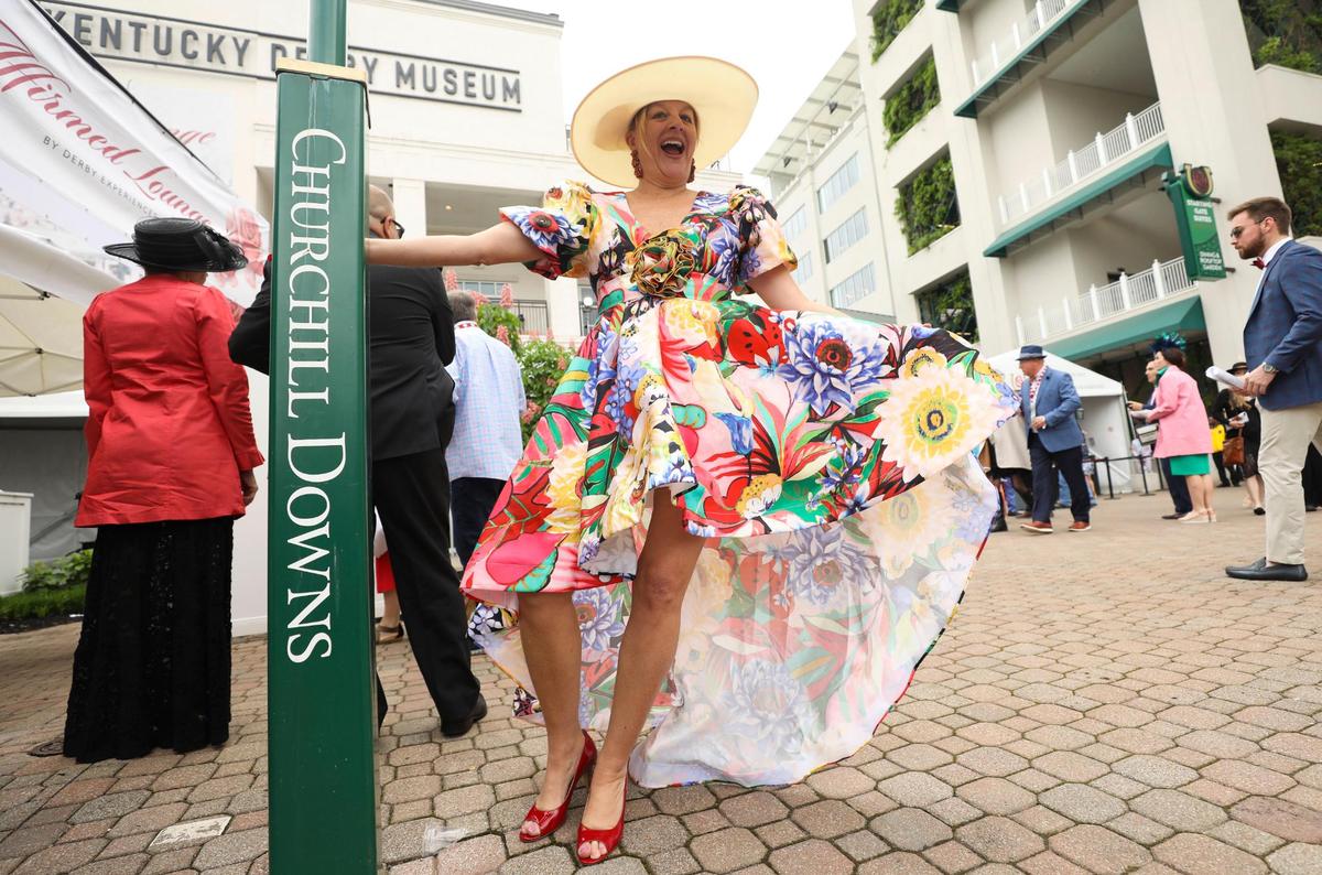 Angie Bush wears a flowered dress at Churchill Downs in Louisville, Ky., Saturday, May 7, 2022. She said she found the dress for $70 an “it screamed Derby.”