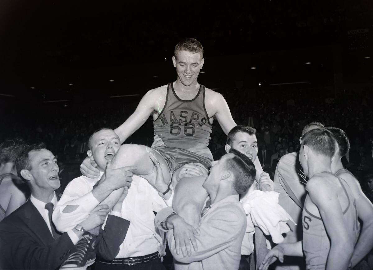 Kelly Coleman, Wayland basketball star, was carried from the floor after he set an all-time four-game scoring record of 185 points in the 1956 Kentucky State High School Basketball Tournament in Memorial Coliseum.