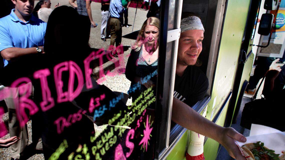 Max Billiat served tacos from his food truck "Hole Mole!" during Food Truck Tuesday last year in Louisville. Some cities have embraced the trucks while others haven't.      