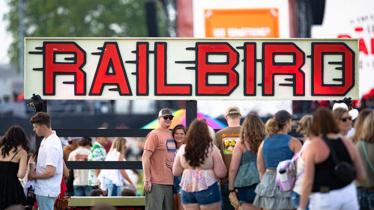 Festival-goers pose for a picture in front of Railbird signage during the 2025 Railbird music festival at The Red Mile infield on May 31, 2205, in Lexington, Ky. 