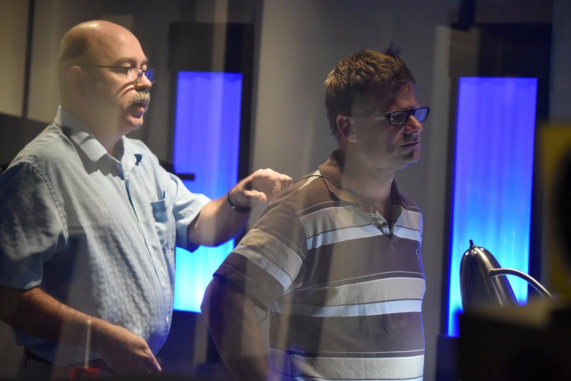 Neil Kesterson pins a microphone to actor Steve Zahn as he prepares to do post-production voice work for the National Geographic series “Valley of the Boom” at Dynamix Productions in Lexington, Kentucky on July 9, 2018.