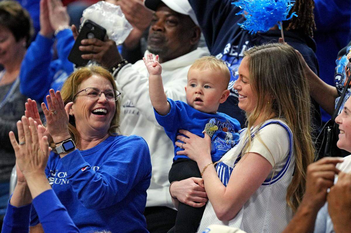Mar 20, 2025; Lexington, KY, USA; Creighton Bluejays guard Steven Ashworth's wife Peyton Ashworth hold their son Tommy Jay Ashworth during the second half of the game between the Louisville Cardinals and the Creighton Bluejays in the first round of the NCAA Tournament at Rupp Arena. Mandatory Credit: Aaron Doster-Imagn Images