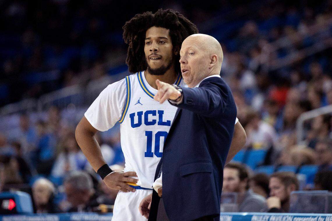 Shown speaking with UCLA point guard Tyger Campbell, left, Bruins Coach Mick Cronin is 75-32 as UCLA head man and led the Bruins to the 2021 NCAA Tournament Final Four.