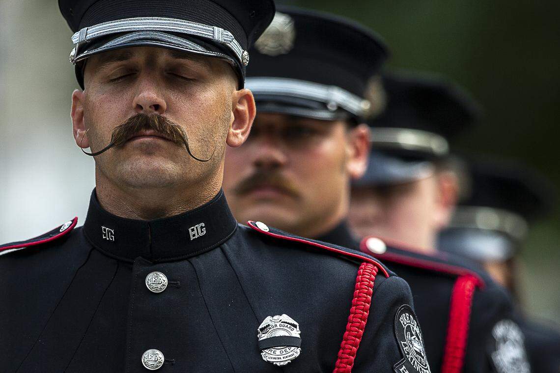 Firefighter Joe Appleget leads members of the Lexington Fire Department’s Honor Guard as they prepare to raise the U.S. flag during a wreath-laying service Wednesday, Sept. 11, 2019, at Phoenix Park in Lexington, Ky., to commemorate first responders killed in the 9/11 attack in 2001.