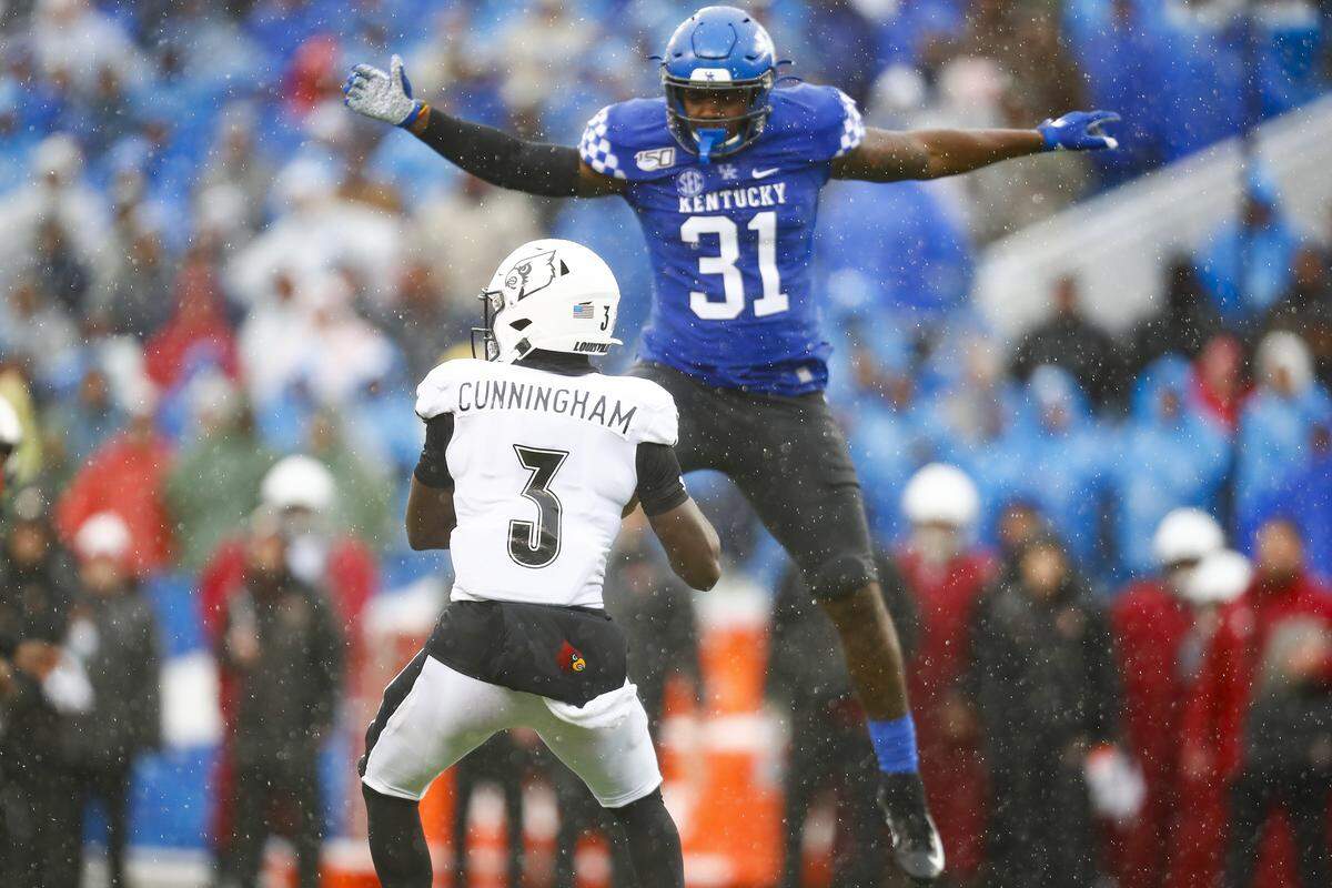 Kentucky linebacker/rush end Boogie Watson (31) pressured Louisville quarterback Micale Cunningham (3) during UK’s 45-13 pasting of U of L last season.