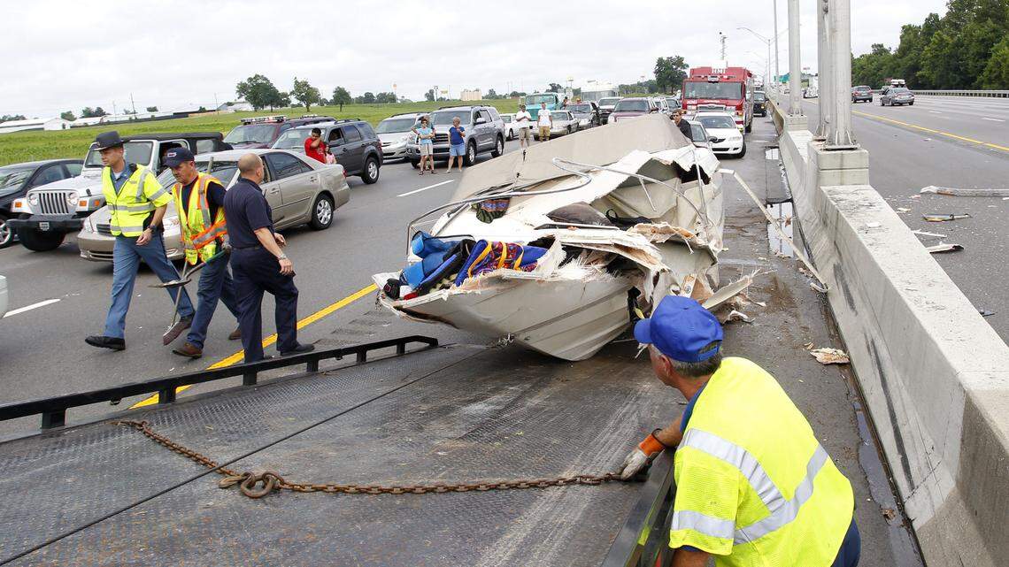 This boat has seen its last lake. It was loaded onto a flatbed truck as police and wrecker crews worked to remove damaged vehicles Friday afternoon. 