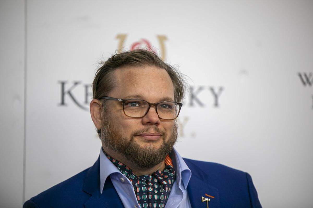 Top-selling author Fred Minnick walks the red carpet at Churchill Downs in Louisville, Ky., Saturday, May 7, 2022.