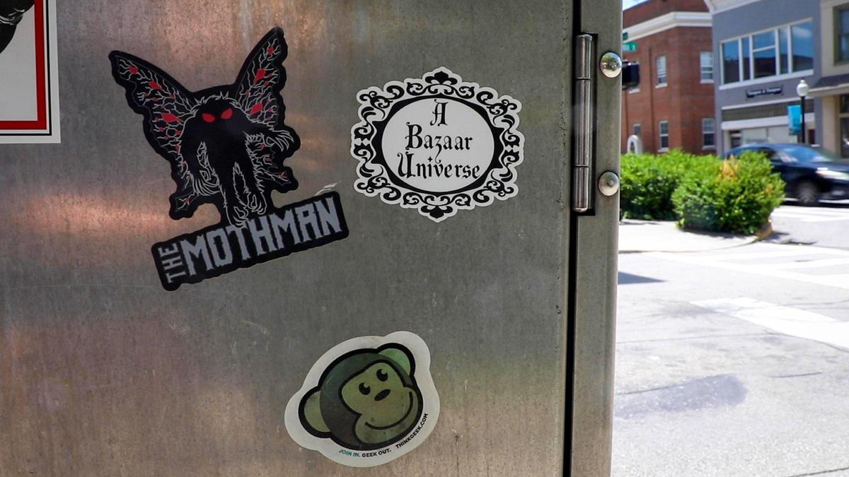 Next to the Paranormal Museum in downtown Somerset, an electrical box is covered in stickers of cryptids and other strange and unexplained occurrences.