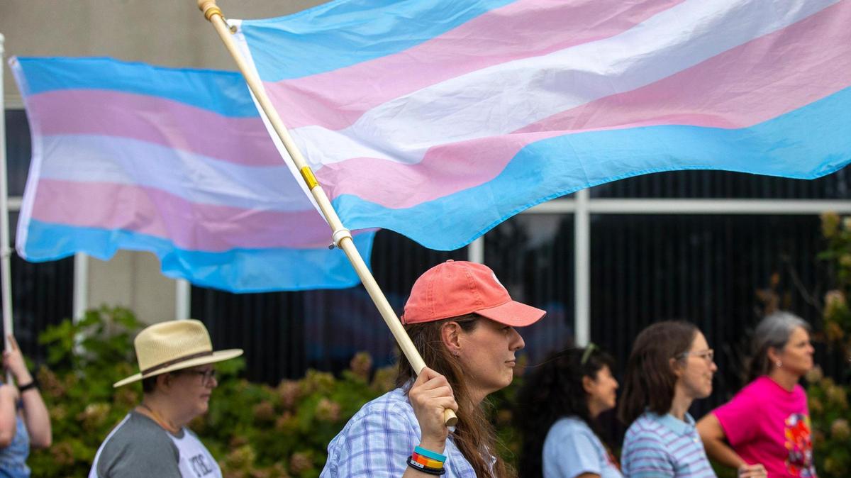 Serenity Johnson, of Hardin County, attends a rally in support of trans youth in schools on Monday, June 26, 2023, outside the Fayette County Public Schools central office in Lexington, Ky. Speakers at the rally asked the Fayette Board of Education to support transgender students, specifically with changes to school bathrooms.