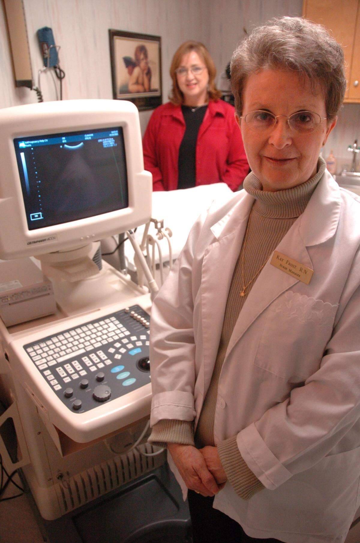 Nurse manager Kay Frost, right, and executive director Cindy McDaniel, left background, are shown with sonogram equipment at the AA Pregnancy Help Center on Jan. 26, 2006 in Lexington, Ky. The sonogram can show a fetus’ development inside the womb of the client. The center encourages women not to have abortions.