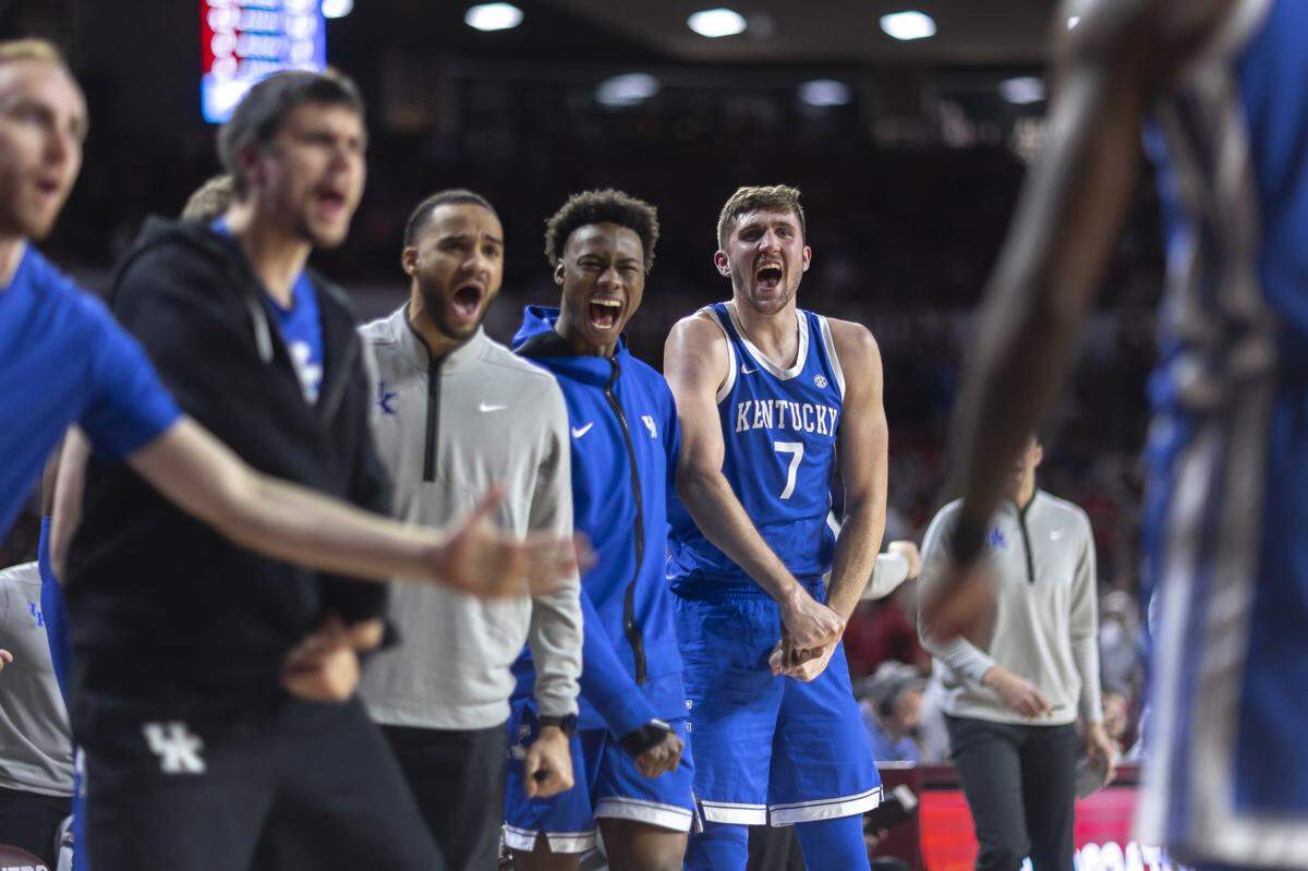The Kentucky bench, including Andrew Carr (7) and an injured Jaxson Robinson, to his right, cheers during Wednesday’s game against Oklahoma at Lloyd Noble Center in Norman, Okla.