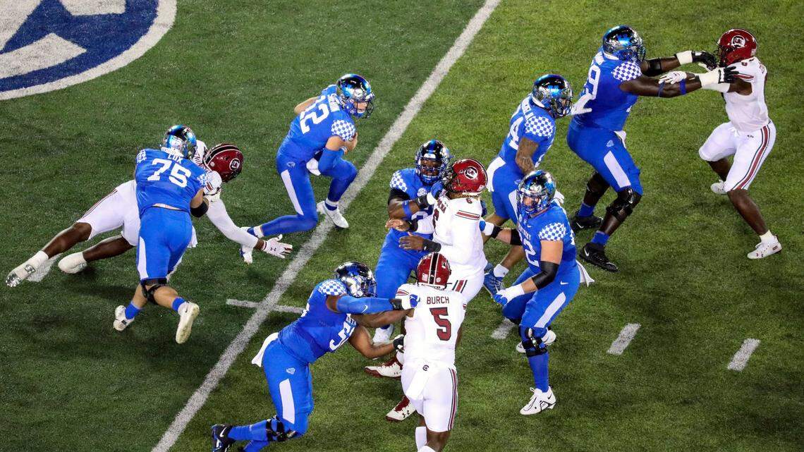 Kentucky quarterback Kaiya Sheron (12) scrambles as pass protection by the UK offensive line begins to break down during Saturday’s game against South Carolina.