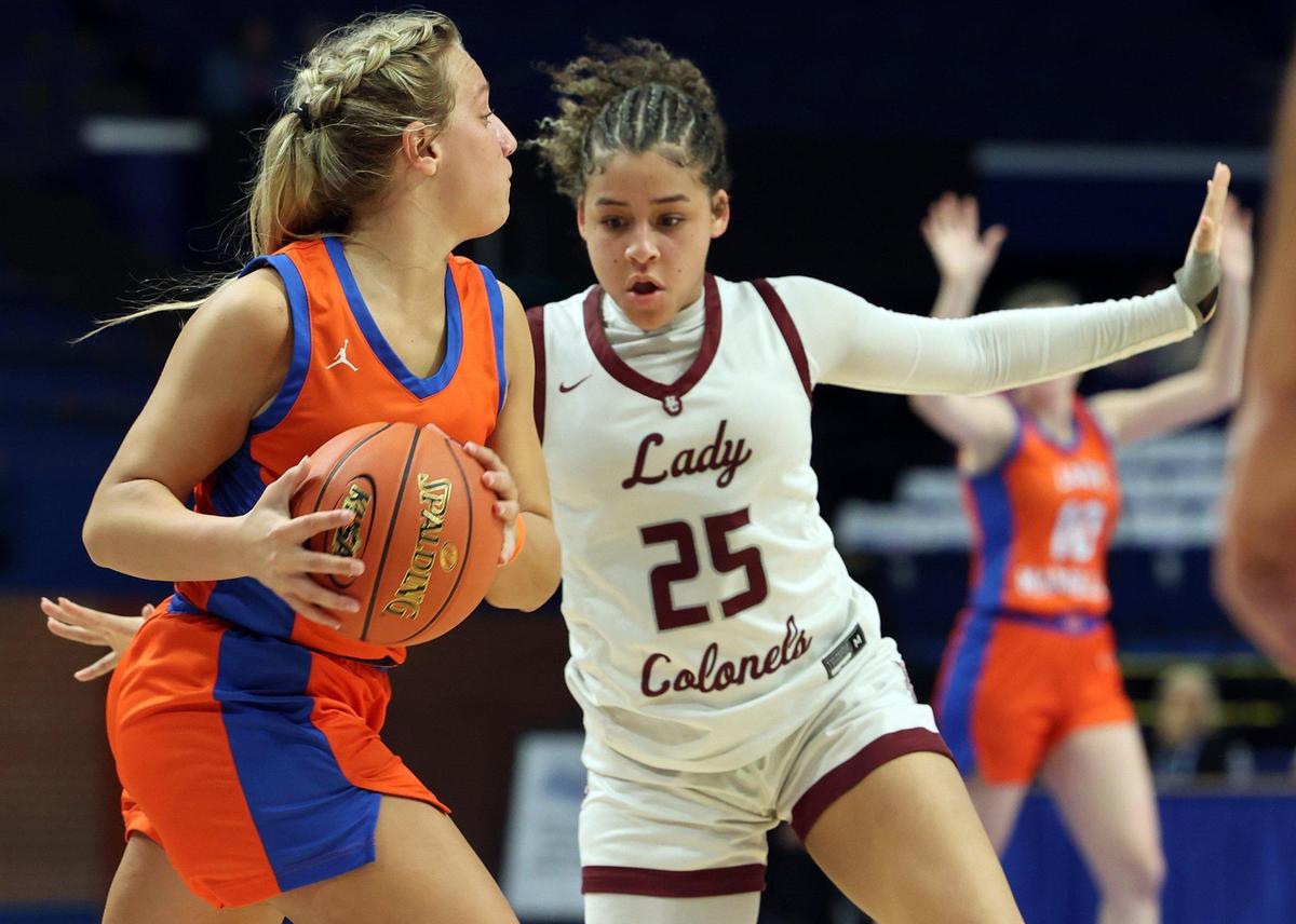 Marshall County’s Skylar Waller (14) looks for an opening on Henderson County’s A’Tylia Green (25) during their first-round game in the Girls’ Sweet 16 on Thursday.