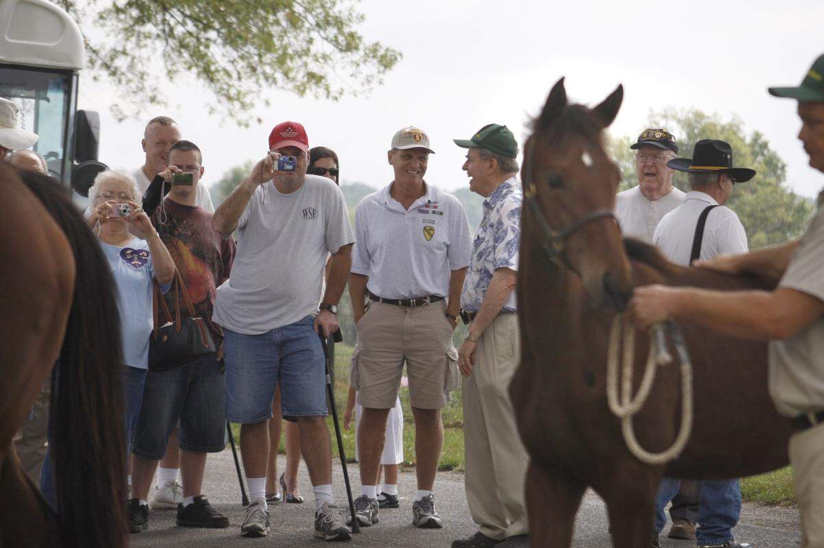 Catesby Clay, center, (turned sideways) the farm’s owner, talked with Vietnam veteran Larry Whelan (hands in pocket) as mares and weanlings were brought in to the barn from their paddock on Thursday, August 28, 2008 at Runnymede Farm in Paris, Ky. Injured soldiers from the Ft. Knox’s Warrior Transition Battalion visited Runnymede Farm, which hosted the soldiers, most of whom were injured in Iraq and Afghanistan, as a way of showing appreciation for their service and sacrifice. The visit was coordinated by the Military Order of the Purple Heart, which also invited Purple Heart recipients from other wars to the tour. David Perry | Staff 6445