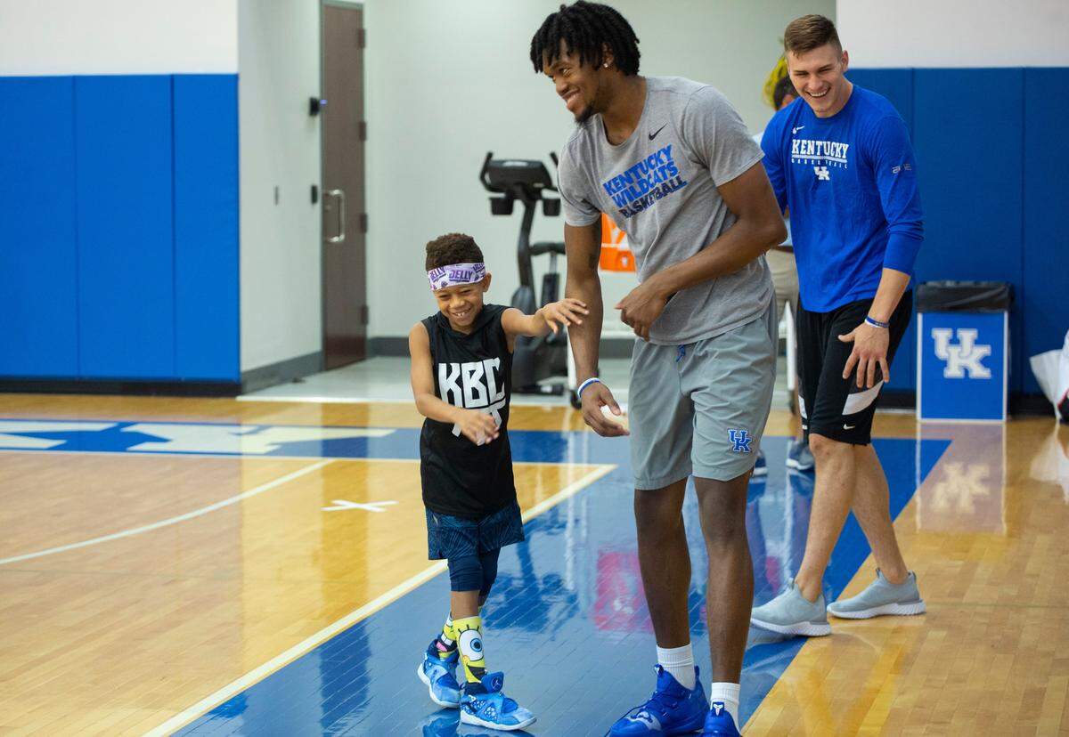 UK freshman Keion Brooks joked with Marques McConnell, 8, during the John Calipari Draft Academy, a youth basketball camp at Memorial Coliseum, on Thursday.
