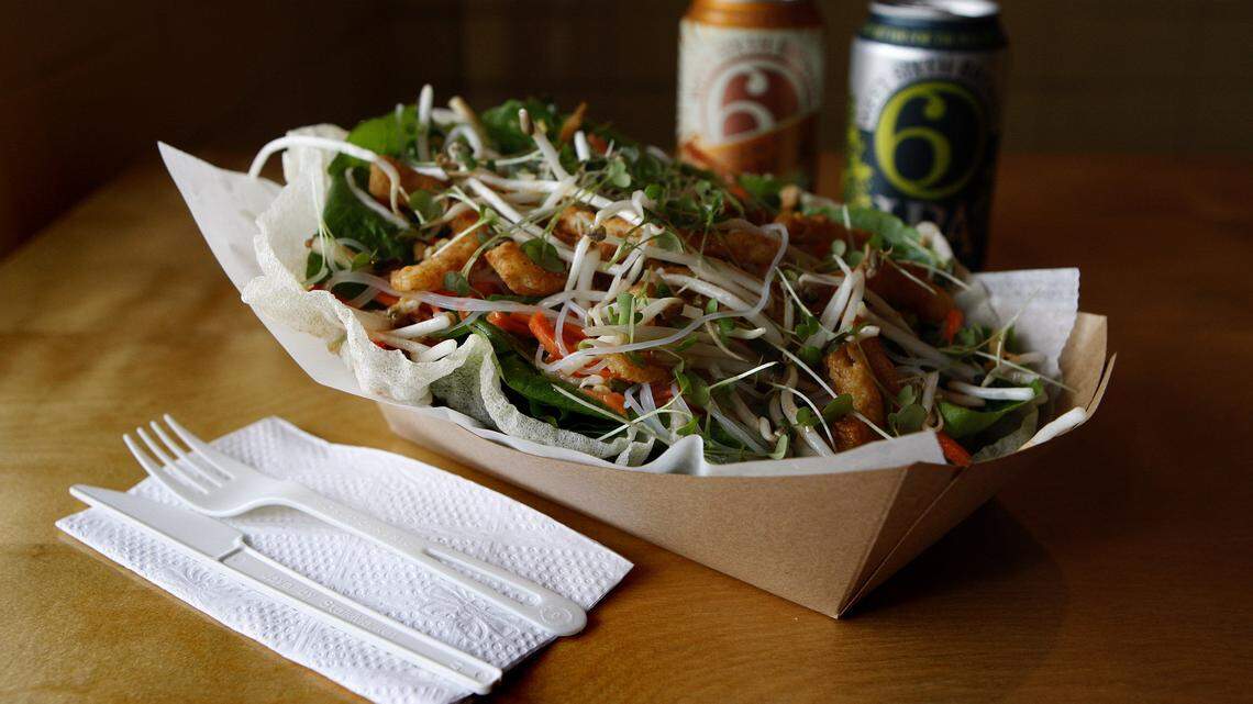 Singapore Salad features FoodChain's special lettuces with sweet-and-spicy pickled vegetables, Thai basil, cilantro, mint, bean sprouts, crispy fried onions and crushed peanuts with rice noodles and Ginger- Soy vinaigrette in a crispy rice paper bowl at Smithtown Seafood in the Bread Box at 501 W. 6th St. in Lexington, Ky., Tuesday, March 10, 2015. Photo by Matt Goins