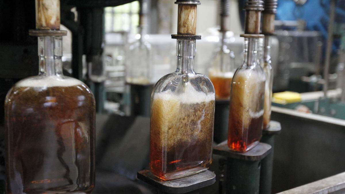 Bottles are filled with Woodford Reserve bourbon on the bottling line at the Woodford Reserve Distillery near Versailles July 24, 2013. Photo by Charles Bertram | Staff      