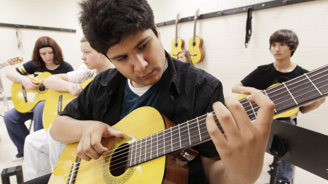 The Fine Arts Academy at Bryan Station High School, which will be expanded for the 2014-15 school year and renamed StationArts, includes guitar classes. Among the students is Michael Childrey, 14, who practiced with his classmates last week. 