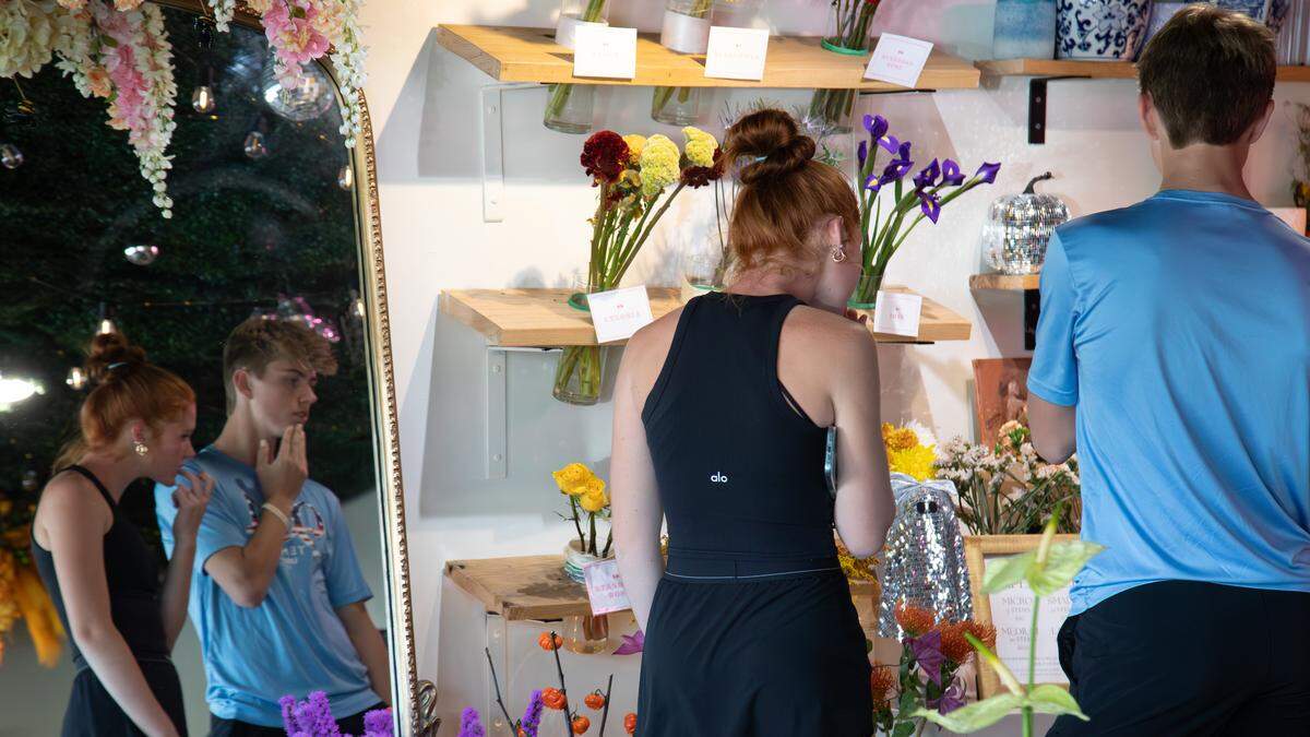 Young customers stop by Poppy’s Flower Bar, checking out the assortment of floral arrangements on Oct. 4, 2025, in Lexington, Ky.